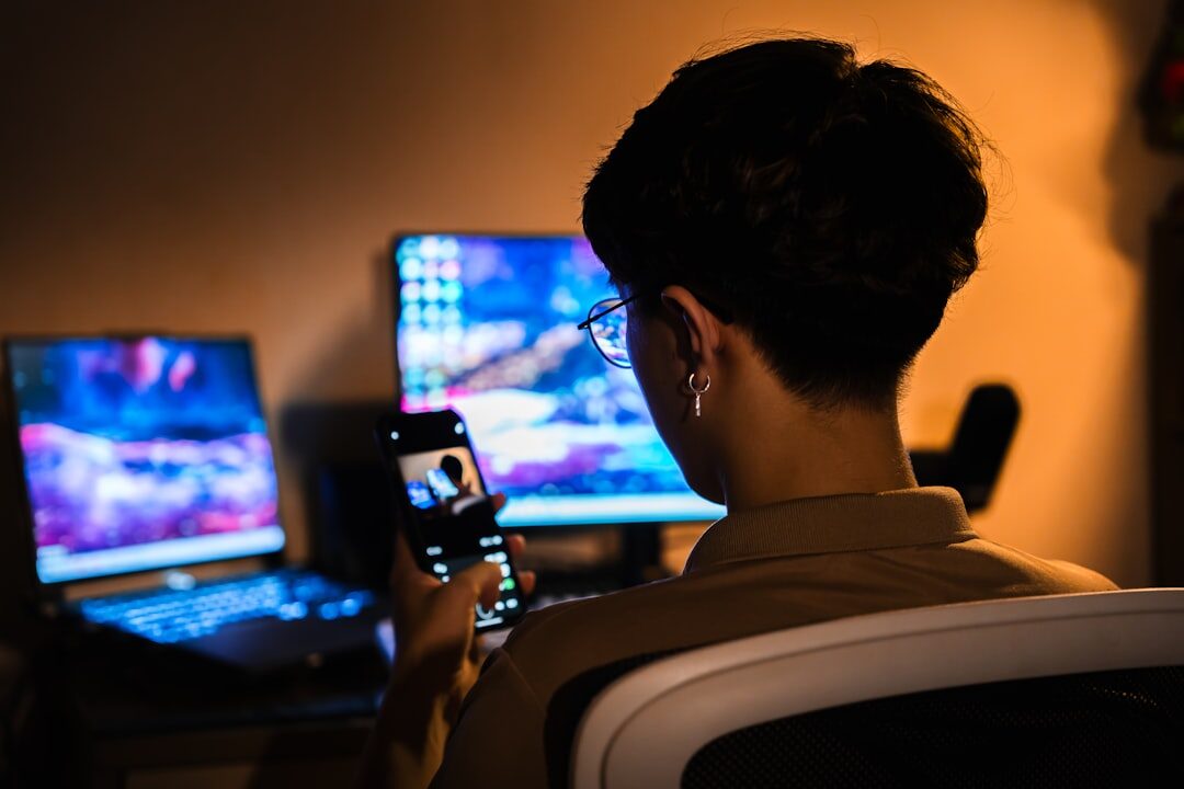 writer typing on laptop in dark room