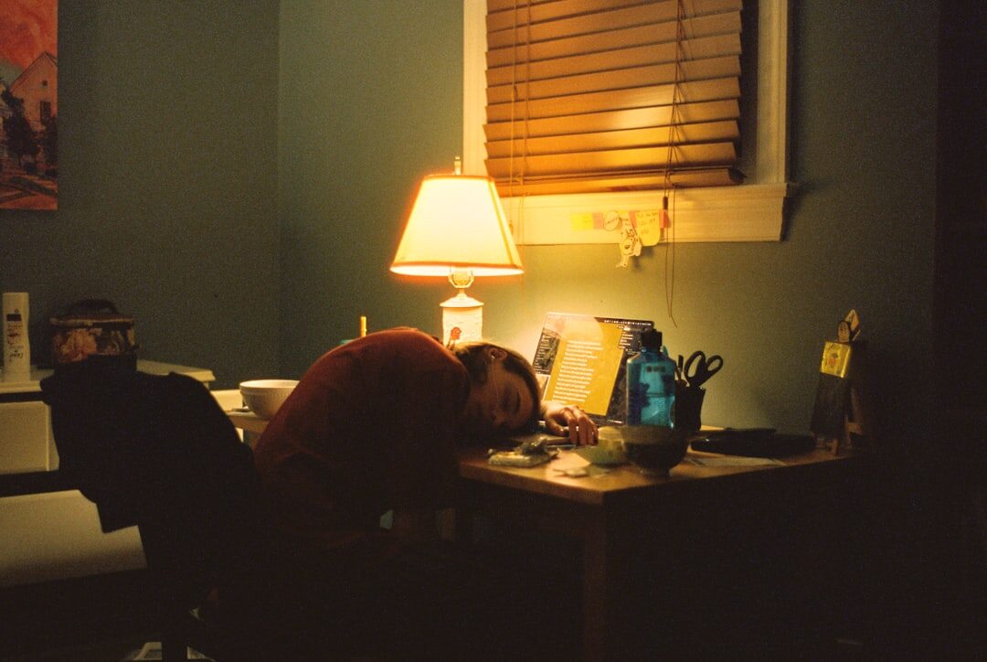person reading book by lamp