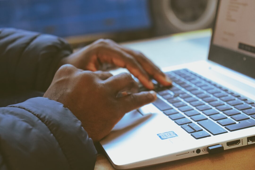 writer typing on laptop